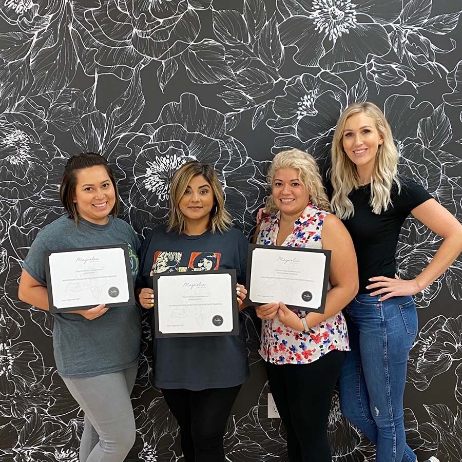 Graduating microblading students with certificates